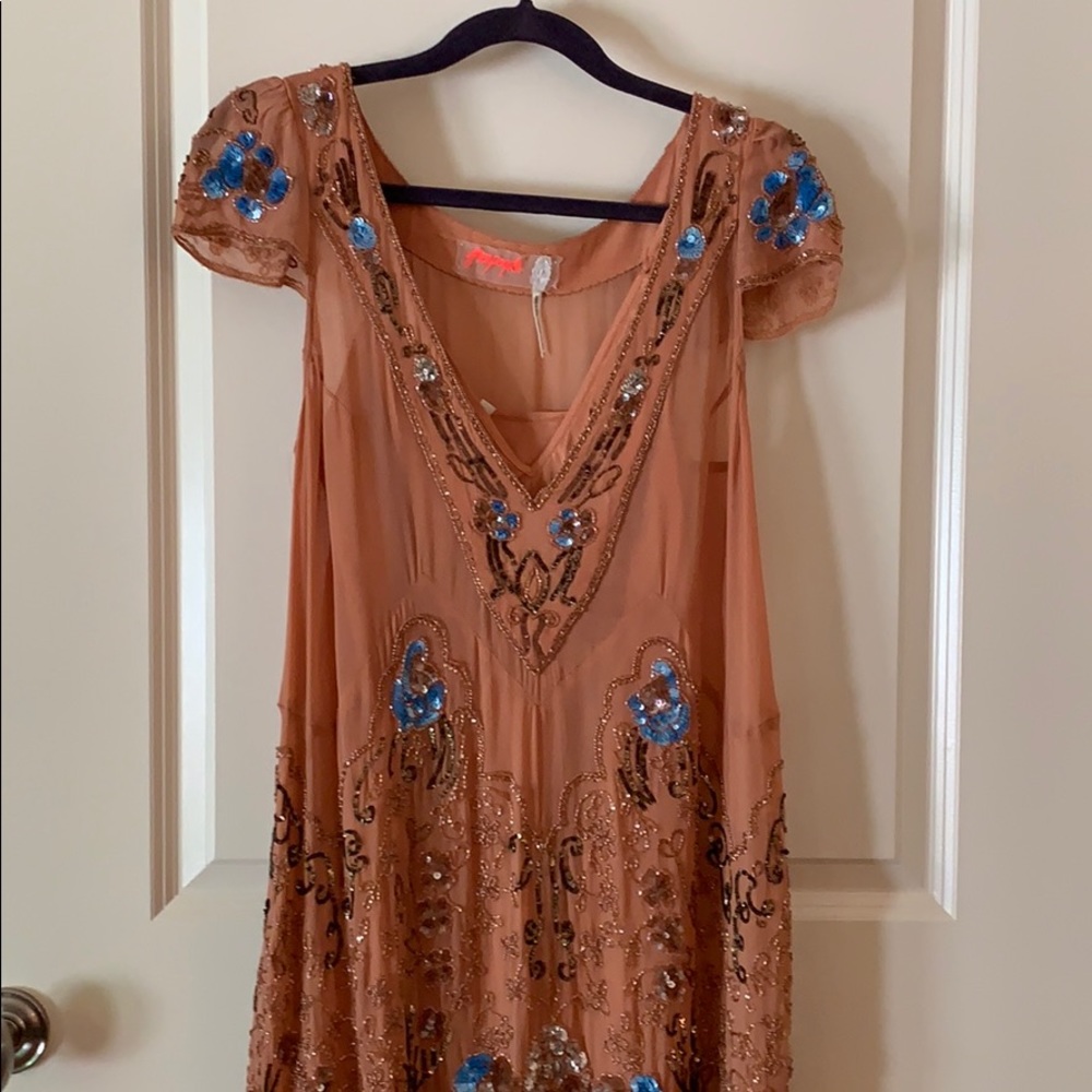 Sheer blush dress with sequined and beaded design.